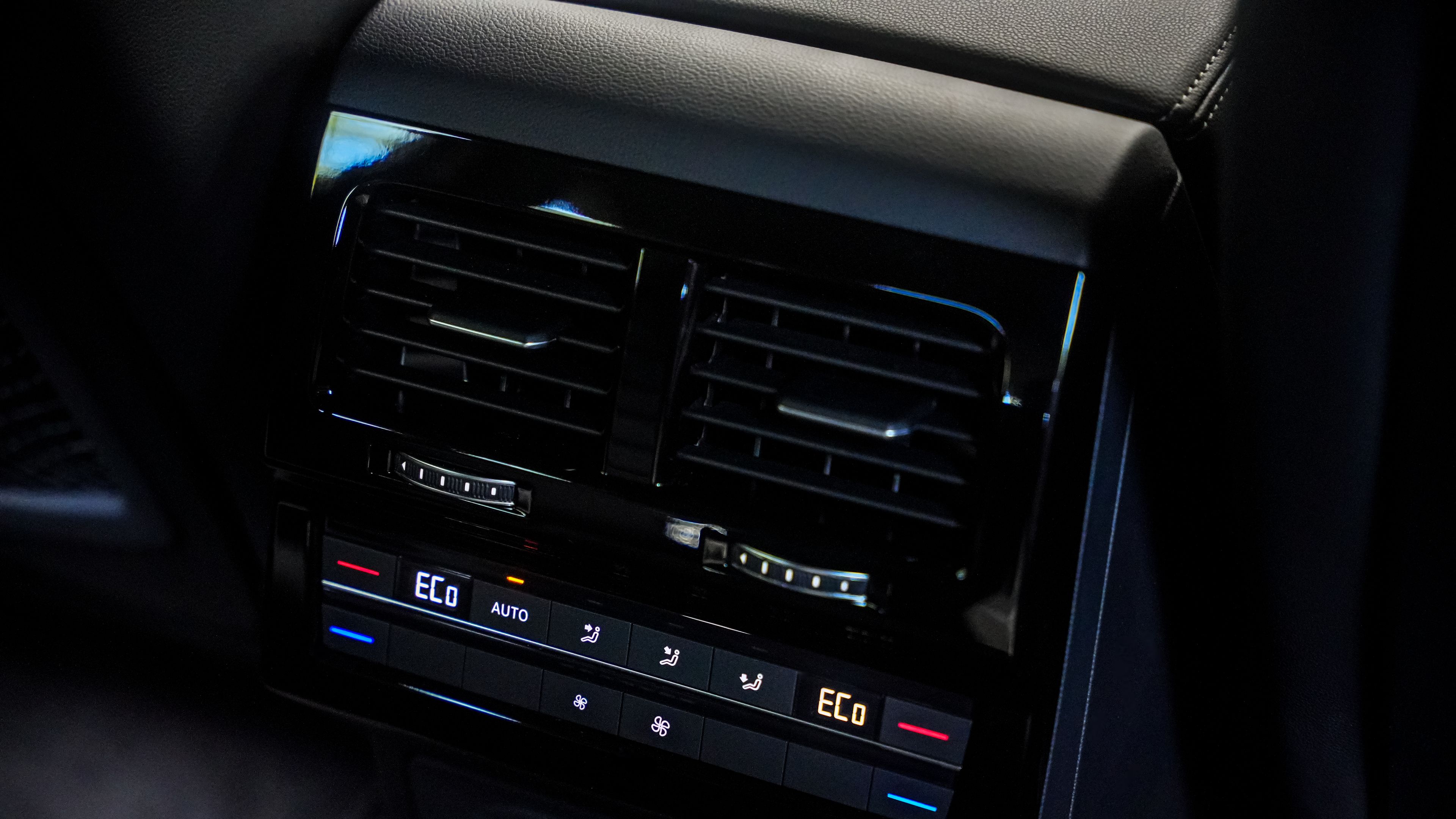 Volkswagen Touareg R-Line | 4-zone Air Care Climatronic Climate control system and air vents in a luxury SUV's center console, specifically the Volkswagen Touareg R-Line.