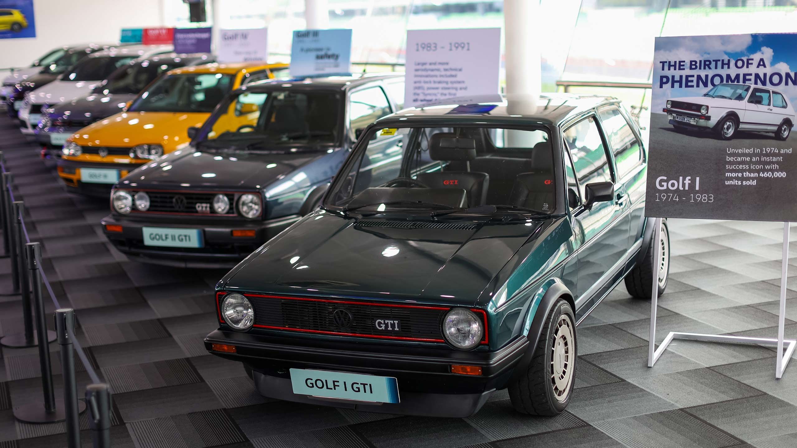 Heritage Display A row of vintage Volkswagen Golf GTI models on display.
