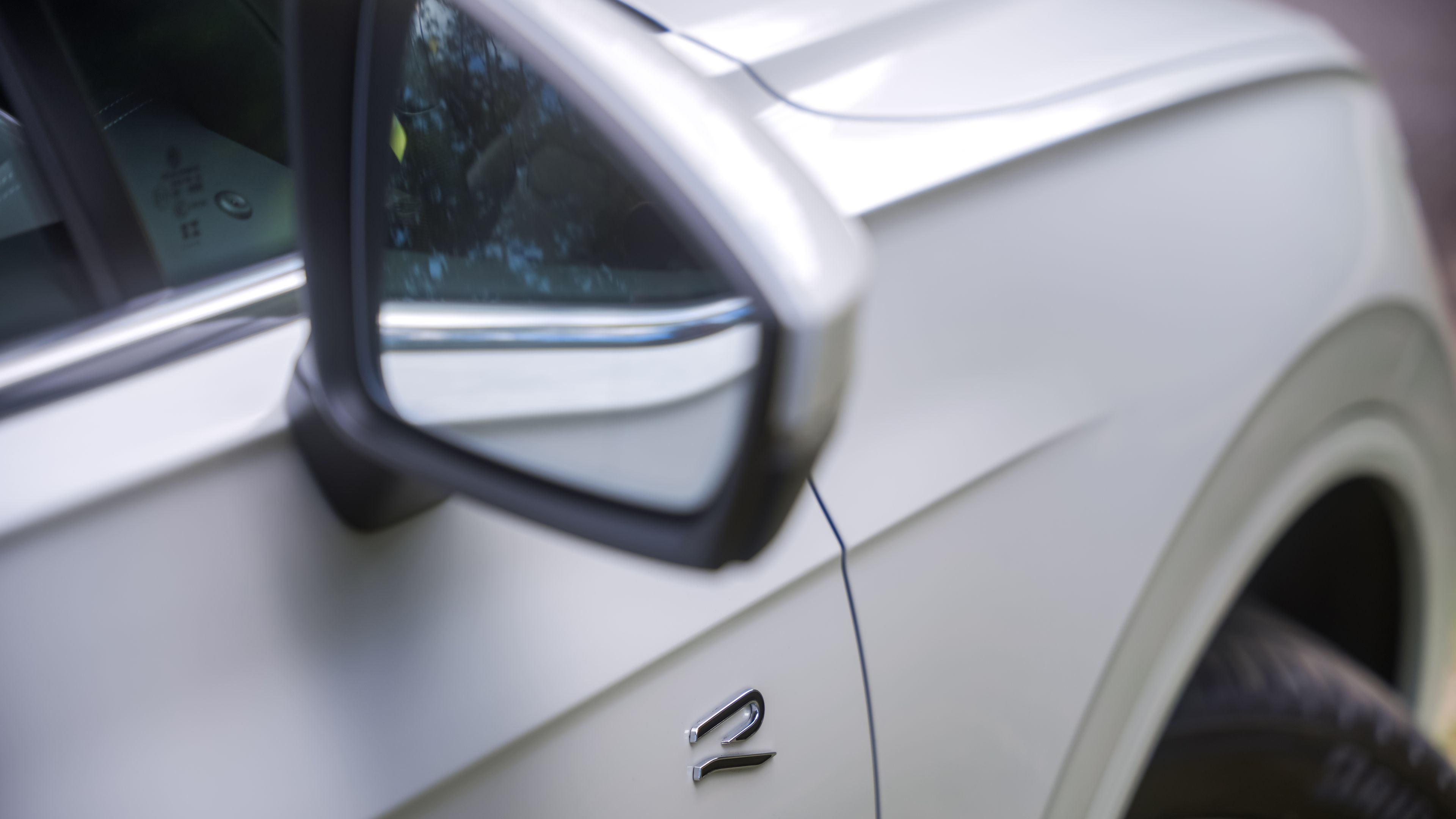 Volkswagen Touareg R-Line | R-Line Styling Close-up of a Volkswagen Touareg R-Line's side mirror and fender, with a focus on the premium design details.