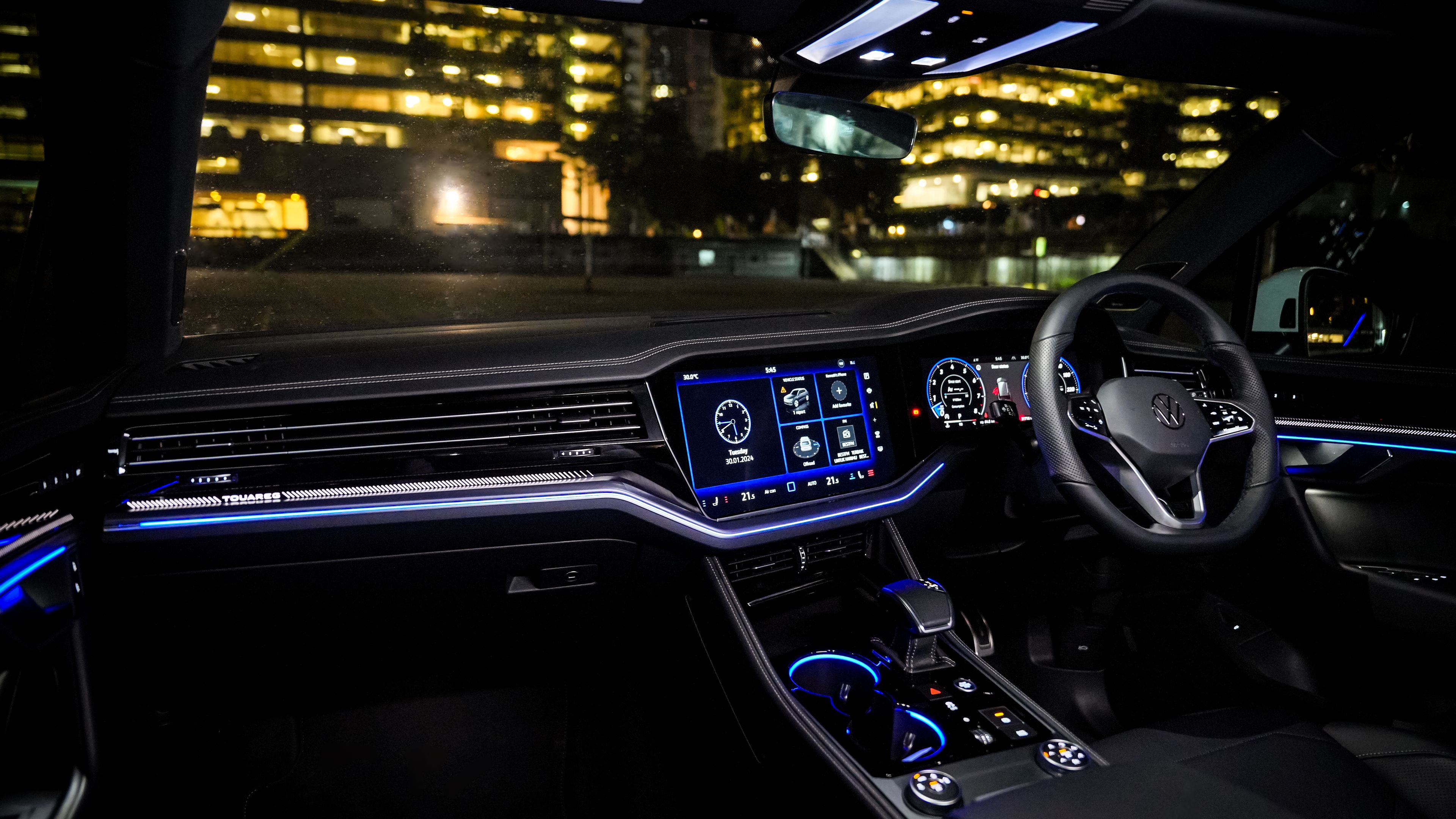 Volkswagen Touareg R-Line Illuminated Volkswagen Touareg R-Line interior at night showcasing dashboard and infotainment system, offering a superior driving experience.