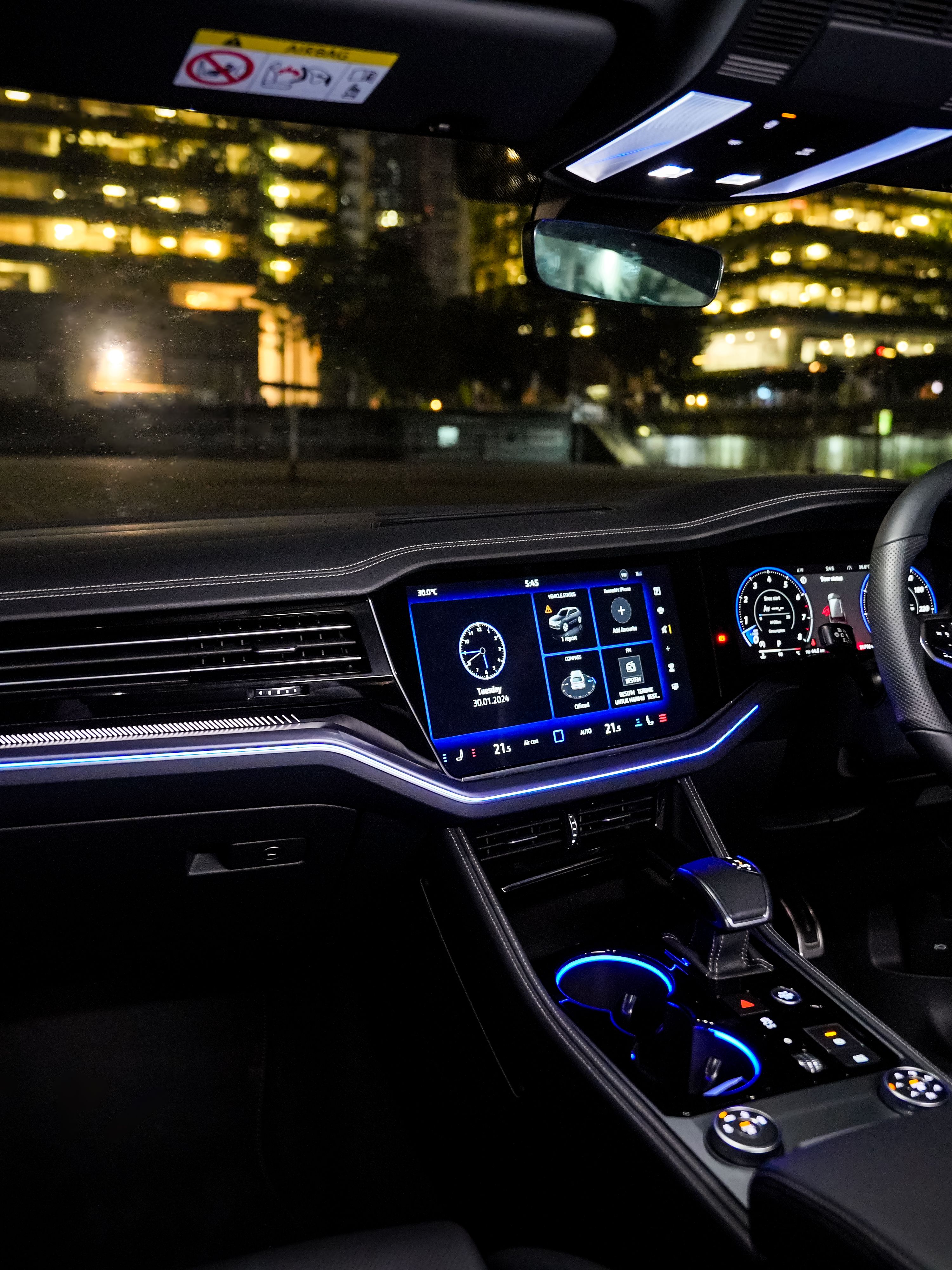 Volkswagen Touareg R-Line Illuminated Volkswagen Touareg R-Line interior at night showcasing dashboard and infotainment system, offering a superior driving experience.
